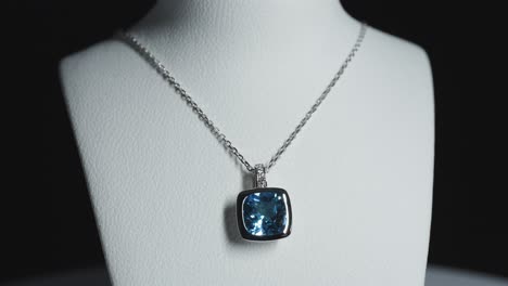 Blue-gemstone-on-a-necklace-on-a-rotating-bust