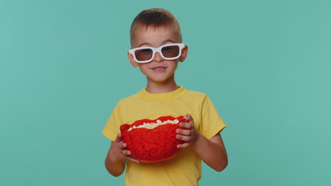 happy cute toddler children boy eating popcorn, watching comedy movie film cinema wearing 3d glasses