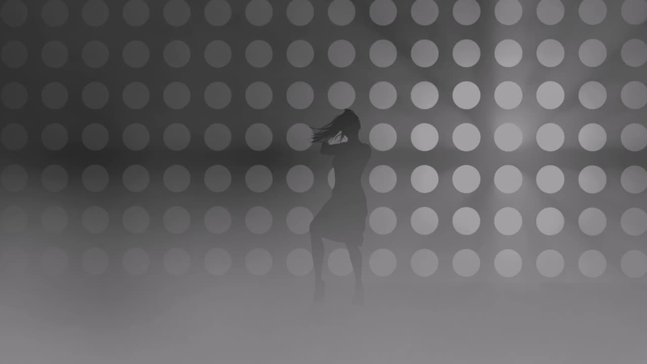 A modern youth dance performed by a graceful and sexy female silhouette, in the smoke against the backdrop of spotlights