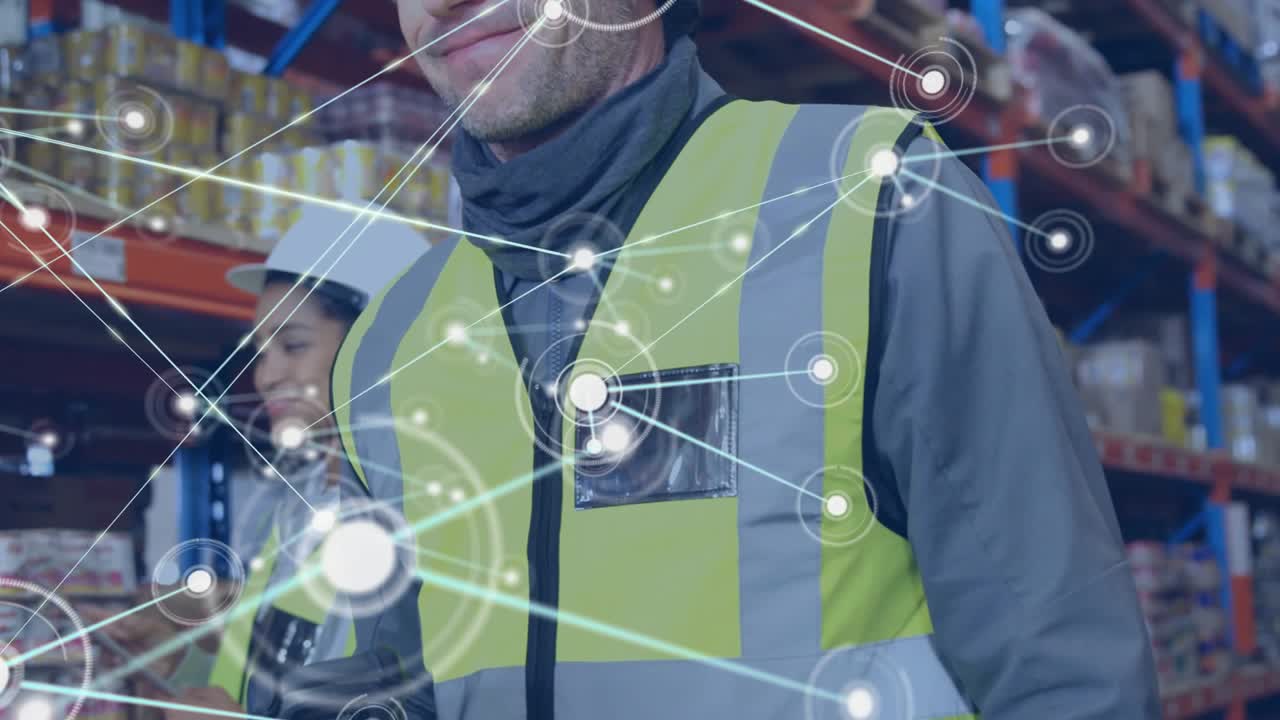 Warehouse worker walking down aisle scanning box tracking inventory while network linking colleague