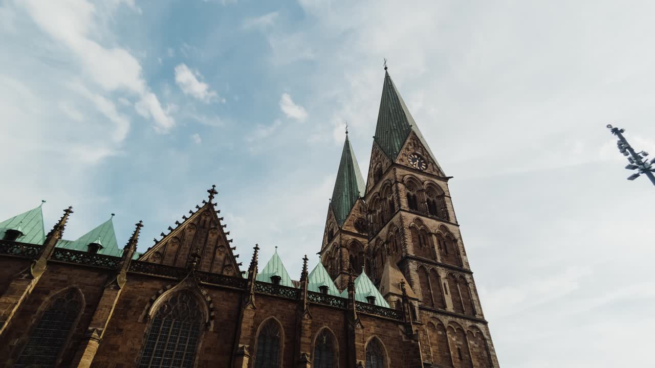 Grand Cathedral with Green Spires Against a Blue Sky