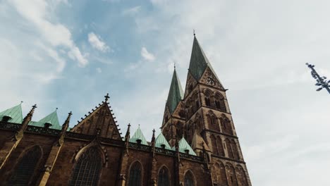 grand cathedral with green spires against a blue sky