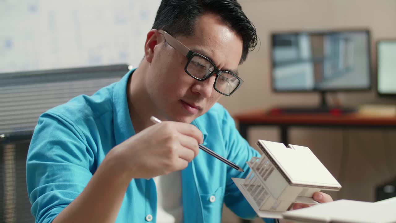 Architect working on building model