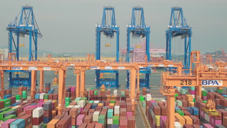 pusan newport international container terminal with huge cranes - aerial view