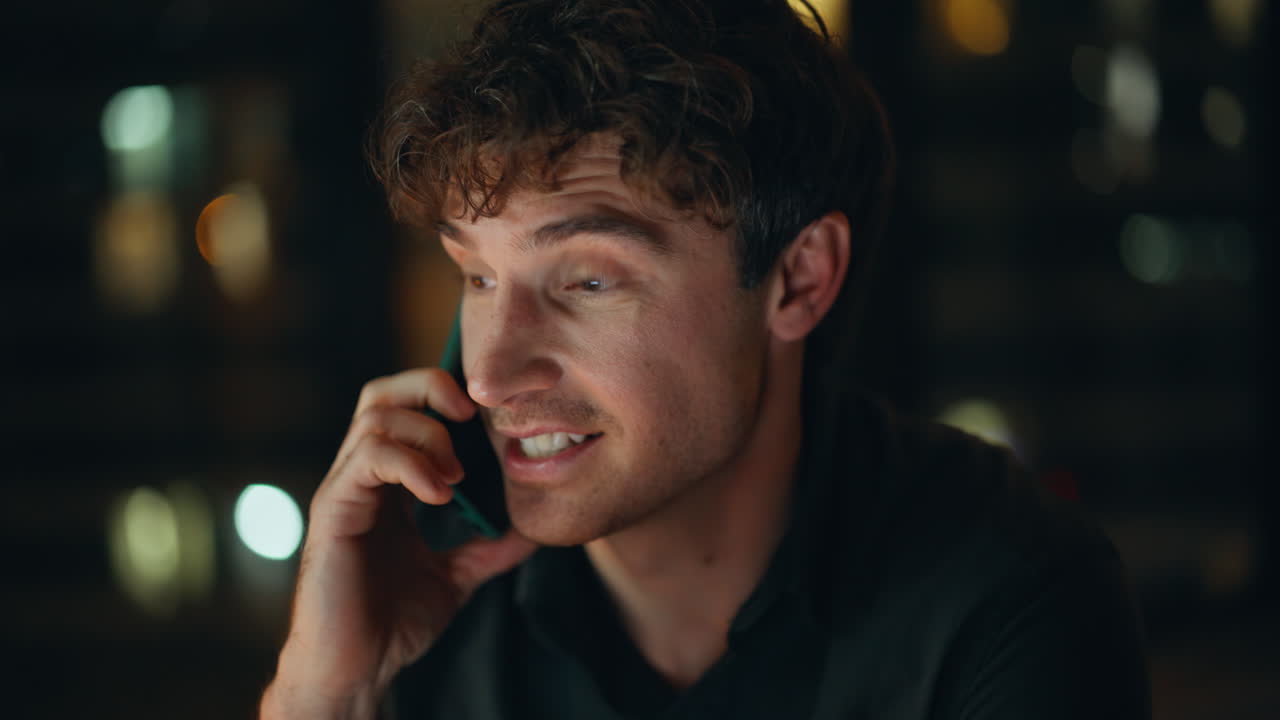 Portrait night manager calling cellphone discussing project. Smiling businessman