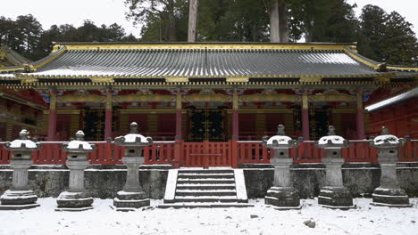 approaching the snow covered entrance to the sanjinko, toshogu shrine, nikko, tochigi, japan.