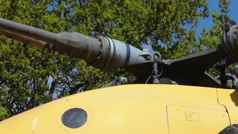 close up panning shot of blades on a yellow helicopter in a children's playground at battersea park.