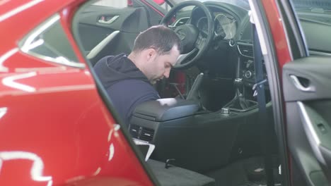 professional car cleaning. сar wash. interior detailing. dry clean and detail a car interior. deep seats cleaning. wiping foam in car wash. cleaning the car panel from dust. a vacuum cleaner