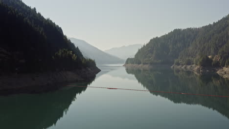 Aerial-shot-over-Cougar-Reservoir-in-Oregon-with-camper-van-parked-on-dam