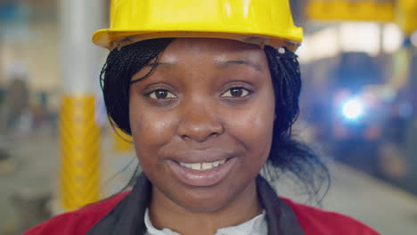 portrait of female factory worker smiling on camera