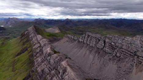 Cinematic aerial view of snowy Andes mountains in Peru with glaciers, rocky cliffs, and hidden blue alpine lake under misty clouds, dramatic landscape and natural travel destination
