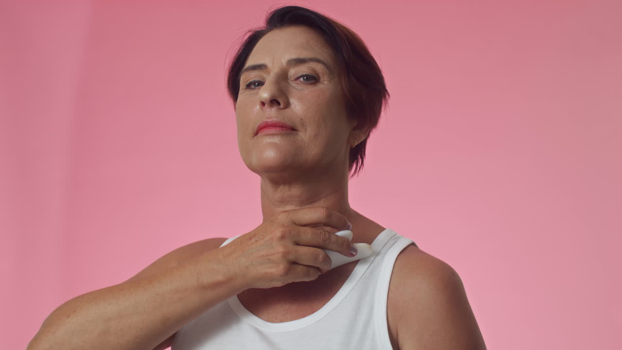 Middle-aged Caucasian Woman Massaging Neck Bottom-up