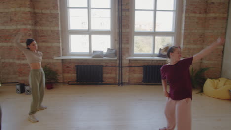 young people dancing at group lesson in studio