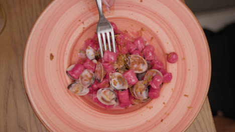 fork inside the gourmet dumplings dish with clams