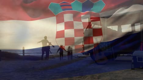 animation of waving croatia flag over silhouette of happy family running at beach during sunset