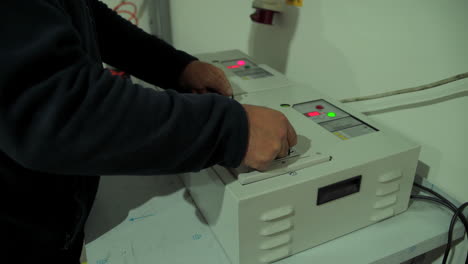 Technician working on industrial electrical equipment