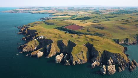 scotland countryside from the sky: st abbs head and lighthouse coastal aerial views, scottish natural landscapes