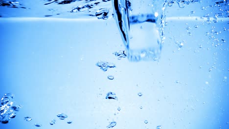 Ice-cubes-dropped-into-water-with-air-bubbles.