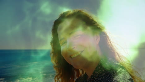 at beach, person smiling with green light animation overlaying scene