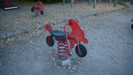 empty playground swings swinging