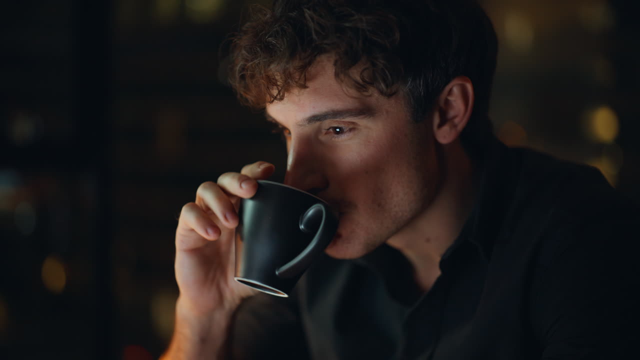 Man hands typing laptop late evening home closeup. Smiling freelancer drinking