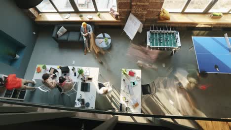 top view time lapse of company staff working in shared office on sunny day moving around