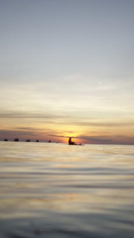 paddleboarding at sunset