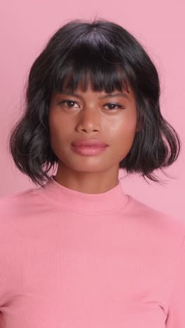 captivating expression of confidence and style in vibrant pink backdrop