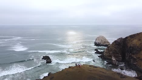 Hikers-taking-in-the-amazing-views-after-a-long-hike-up-a-steep-cliffside