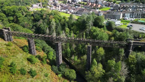 an aerial sideways drone shot of an abandoned bridge in south wales