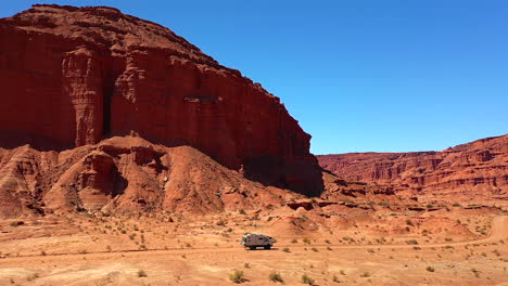 expedition truck driving along ocher cliffs ischigualasto provincial argentina park blue sky overlander