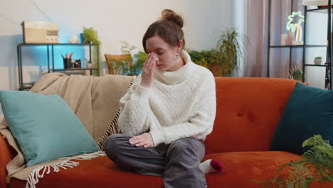 displeased young woman rubbing temples to cure headache problem, suffering from migraine, stress