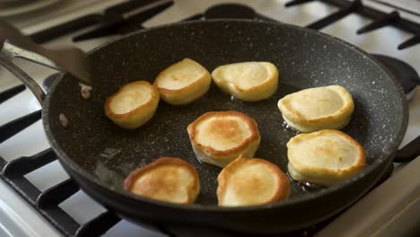 the cook removes the fried pancakes from the pan