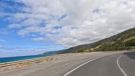 a 13-second video captures a drive along the great ocean road, showcasing coastal views, winding roads, and lush greenery under a bright sky
