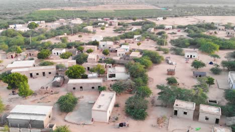 aerial ascending shot with tilt down view of rural village in sindh, pakistan