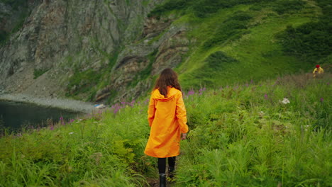 Woman Hiking in Mountainous Coastal Landscape