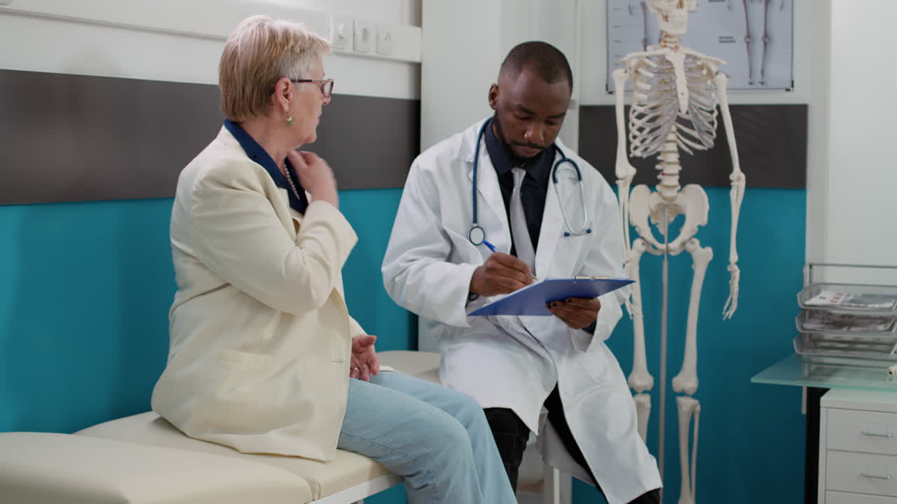 Doctor Consults with Senior Patient in Clinic