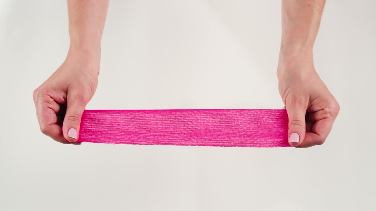 Kinesiology medical taping, doctor Physical therapist applying elastic surgical tape to patient body, treating injured knee young athlete.Post traumatic rehabilitation, sport physical therapy recovery