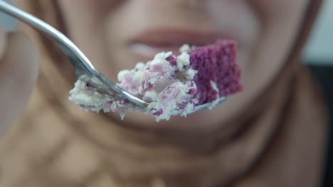 woman eating delicious purple velvet cake