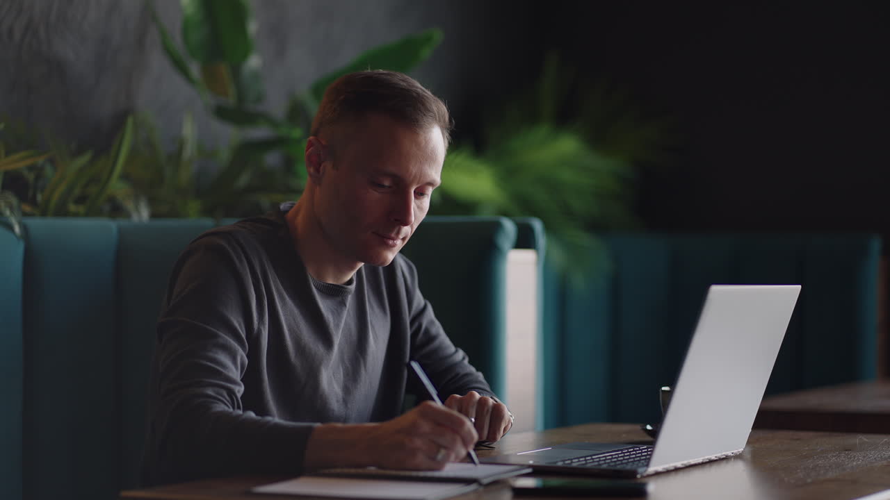 Hispanic latin man college student using laptop computer watching distance online learning seminar class remote university webinar or having virtual classroom meeting in university creative space.