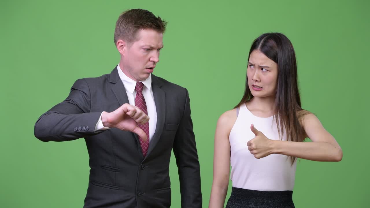 Multi-ethnic business couple having different decisions