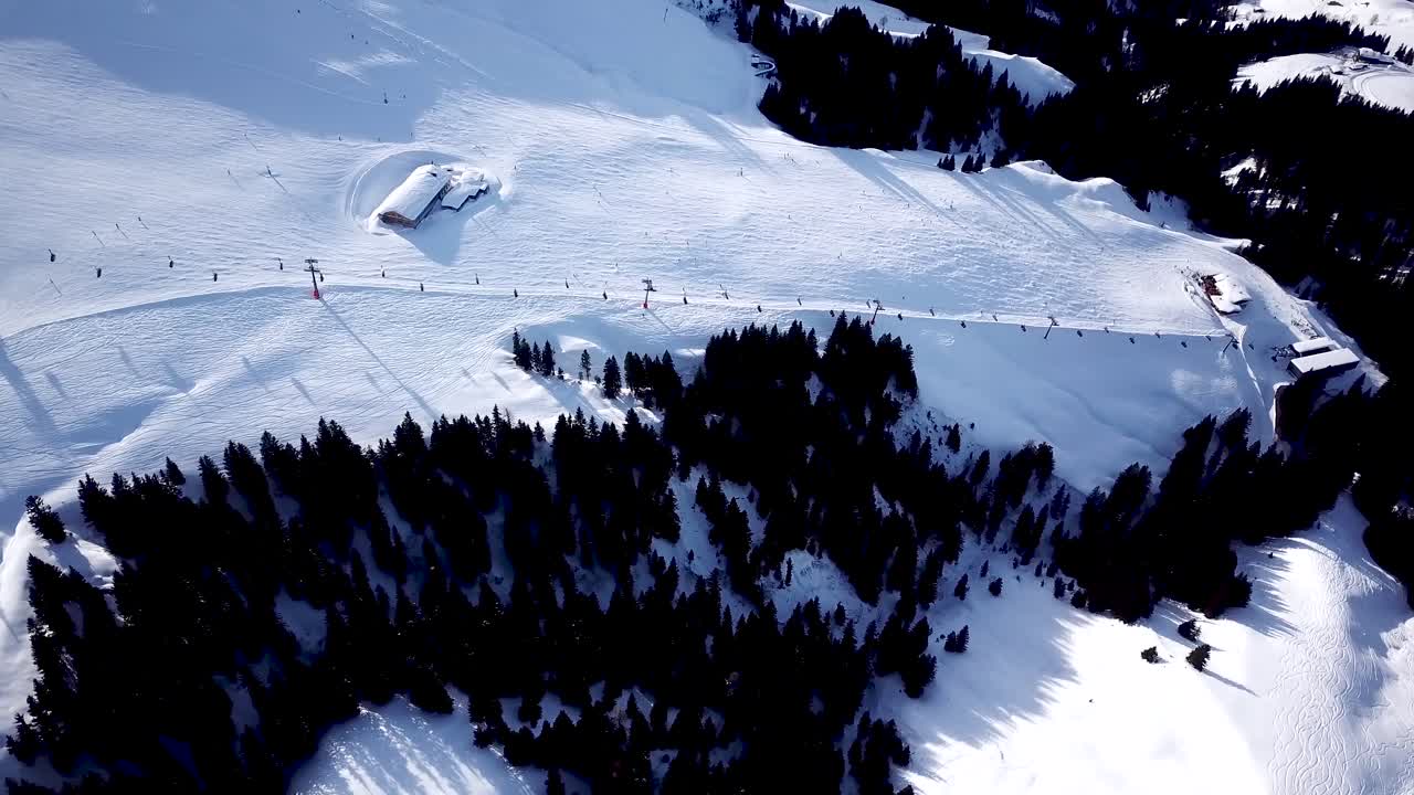 Ski in the Alps with ski lift and people skiing on the slope