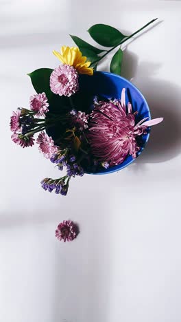 floral arrangement in blue bowl