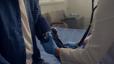 doctor hands measuring blood pressure of elderly man. senior patient health.