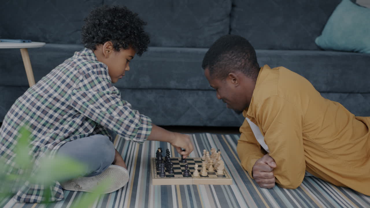 Father and Son Playing Chess at Home
