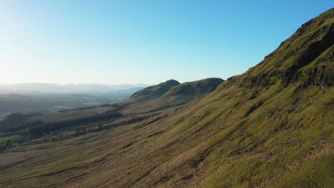 4K-drone-shot-flying-along-hillside-to-reveal-Dumgoyne-Hill-in-distance