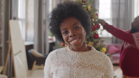 portrait of joyous african american woman at home on christmas day