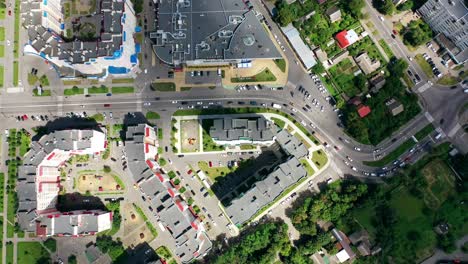 rooftops of modern residential buildings. panoramic view of a cityscape with buildings and moving cars on road. top down view.