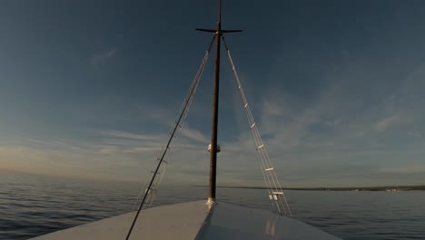 a picturesque shot taken from the front of a sailboat while doing a sea cruise on a summer day