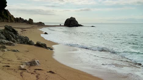 Mediterranean-beach-without-people-at-sunrise-turquoise-blue-calm-water-Barcelona-coast-Maresme-Costa-Brava-Spain-European-tourism